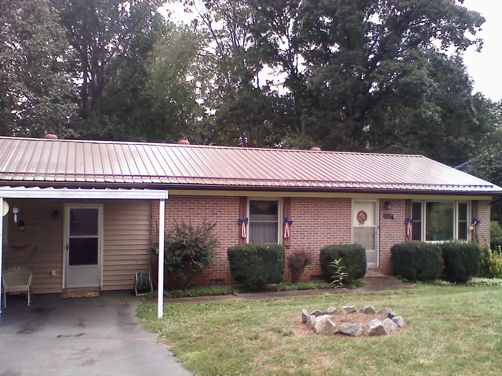 Bronze metal roof and carport on a brick ranch home — Roof Repair work by our crew in Fulks Run