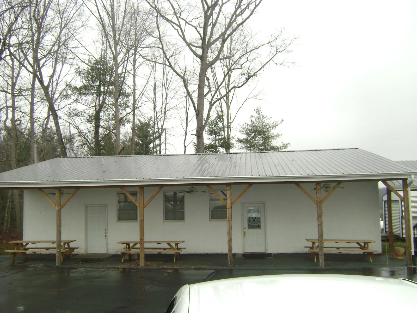 Gray metal roof over a block building with a timber post porch in Fulks Run